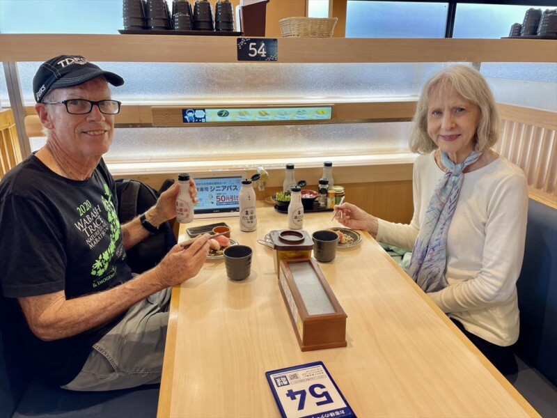 Enjoying a meal at a conveyor belt sushi restaurant