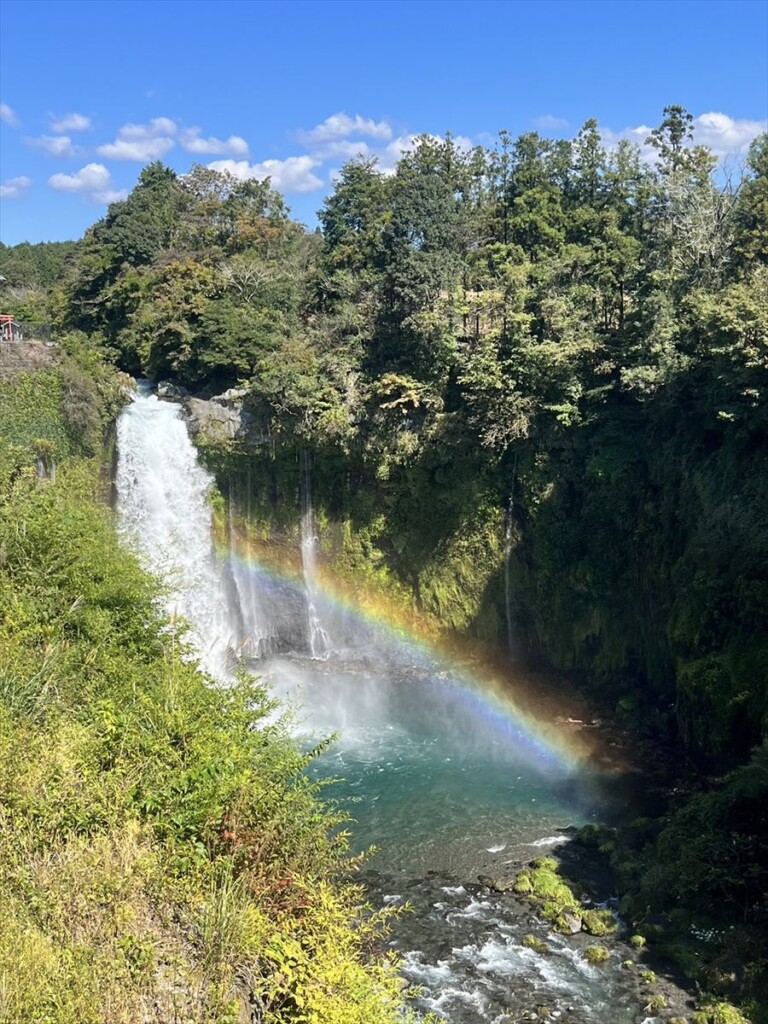 Otodome Falls with a rainbow spanning the misty air above the water.