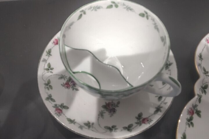 Close-up of a traditional mustache-protecting teacup, a historical household item used to enjoy tea without wetting facial hair.
